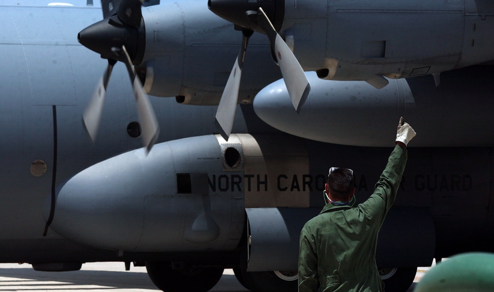 A maintanence worker at the Peterson Air Force Base in Colorado Springs gives a thumbs up to crew on a C-130 aircraft.